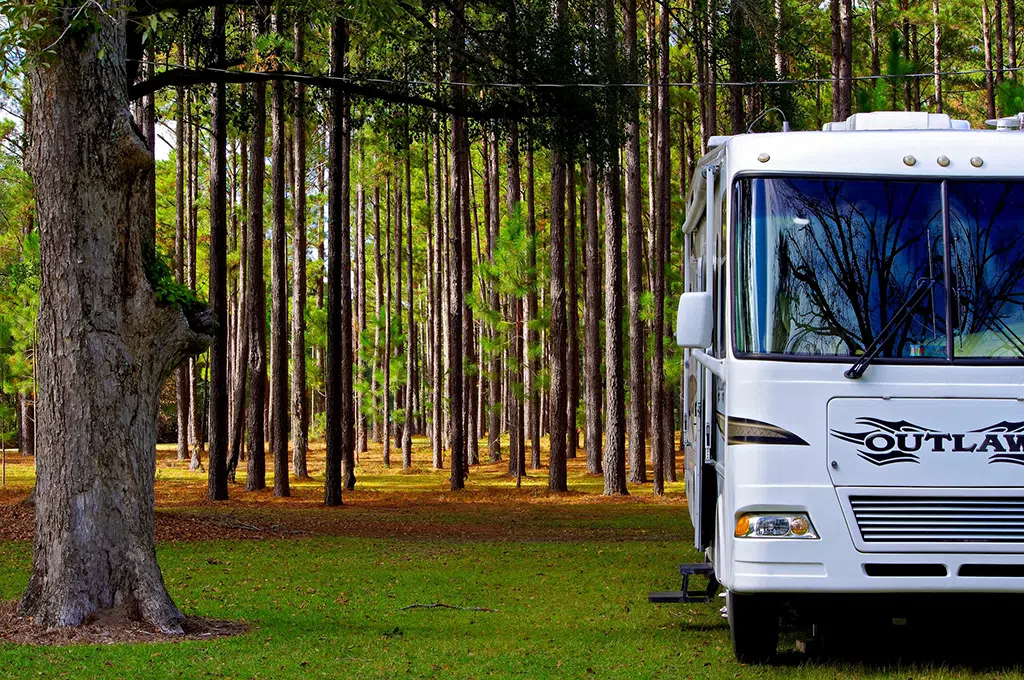 Outlaw Class A RV parked in the woods
