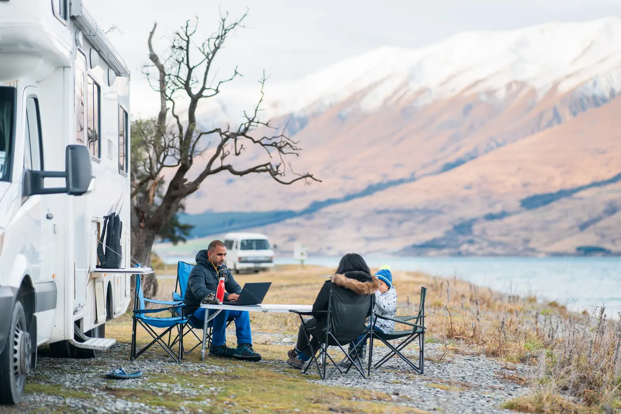 Family hanging out next to Class C motorhome RV
