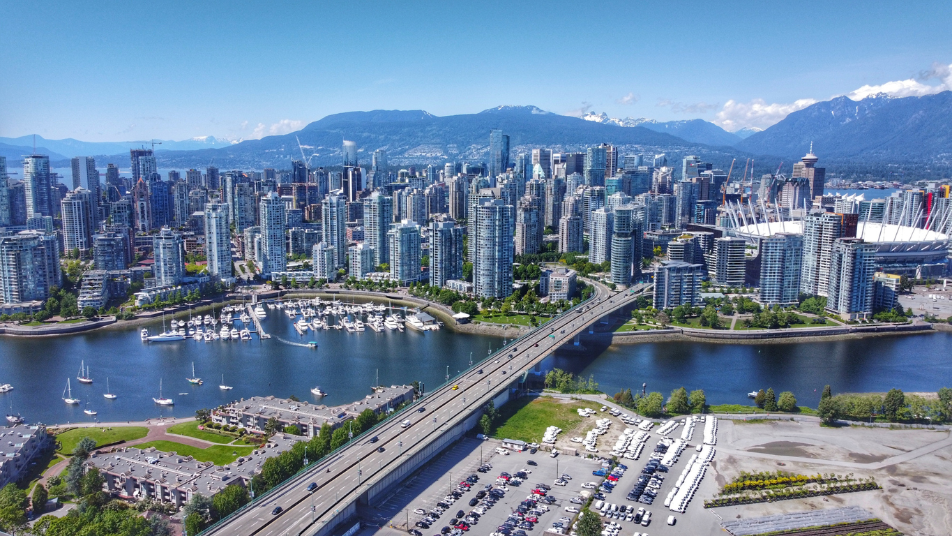 Aerial shot of downtown Vancouver, Yaletown, North Shore mountains, BC Place, False Creek and the Cambie bridge.